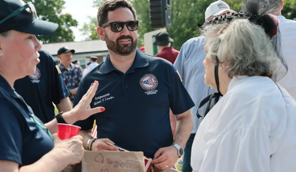 Rep. Mike Lawler campaigning in New York's 17th Congressional District during the 2026 election while highlighting campaign fundraising efforts.