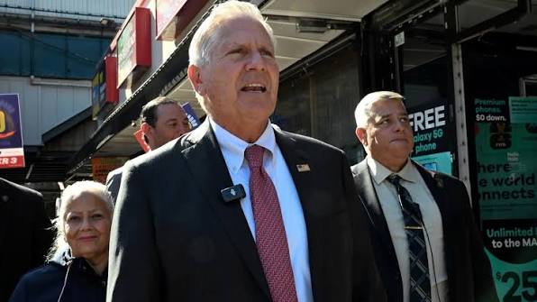Bruce Blakeman speaks at a podium as New York Democrats seek an investigation into his campaign finance reports.
